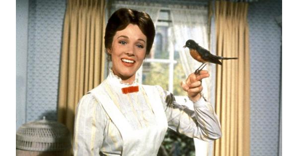 A still from Mary Poppins - mary is smiling with a robin perched on her outstretched finger