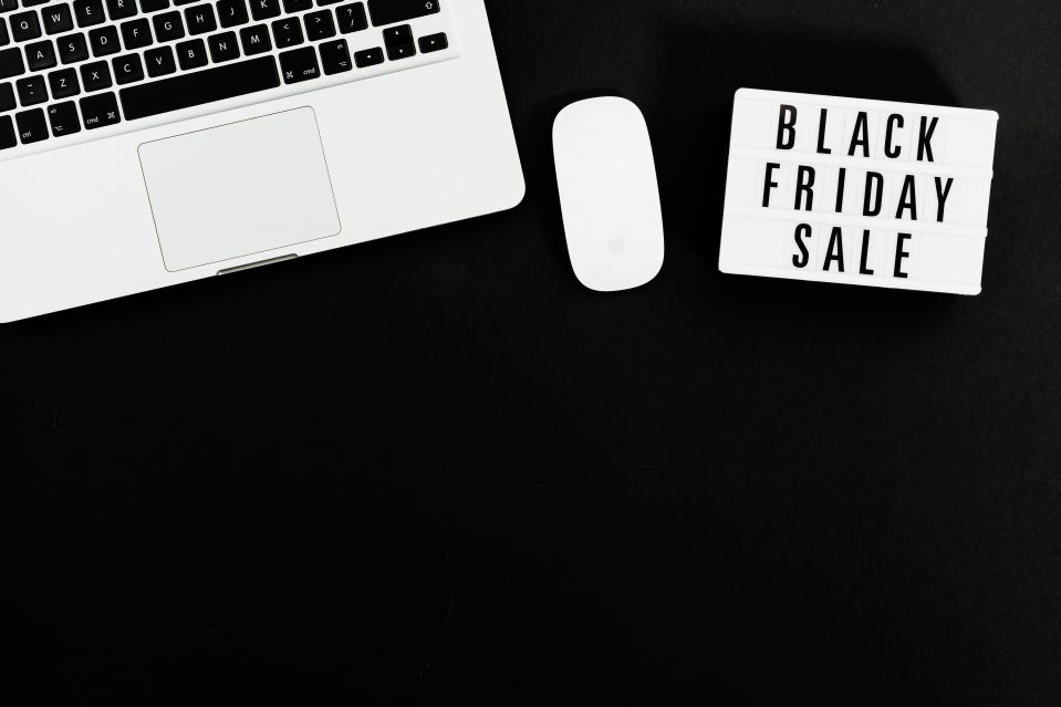 Light box displaying the words BLACK FRIDAY SALE next to a laptop and mouse