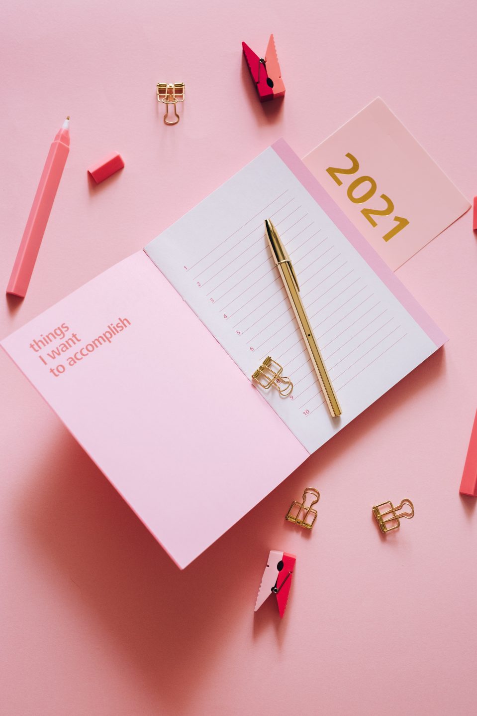 Pink flat lay with 2021 diary open on a page that says 'Things I want To Accomplish'